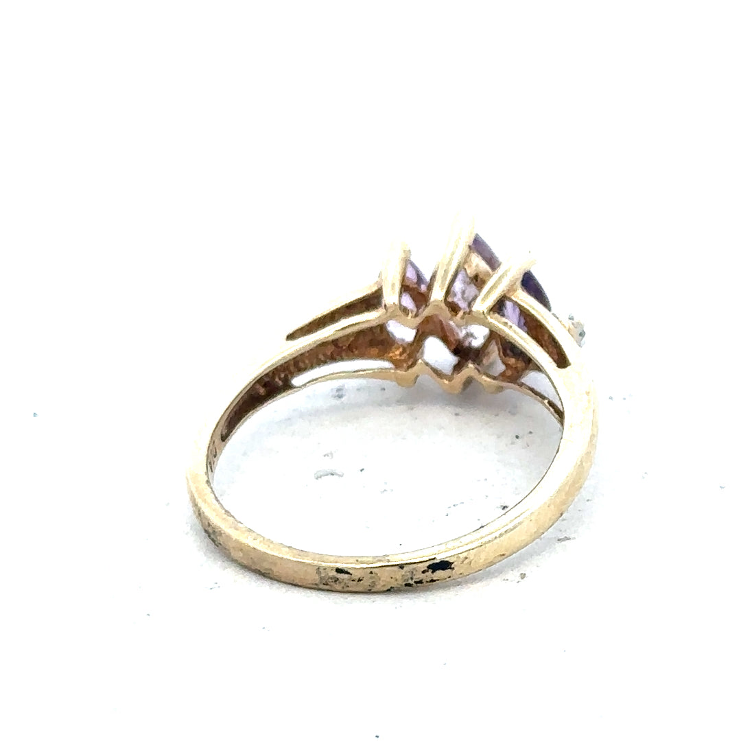 9ct yellow gold amethyst and diamond ring in size P, featuring a central purple gemstone with sparkling side diamonds.