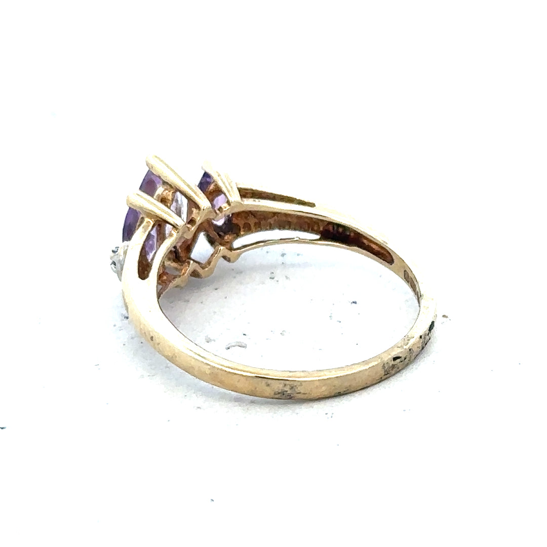 9ct yellow gold amethyst and diamond ring, size P, with a central purple gemstone and sparkling accent diamonds.