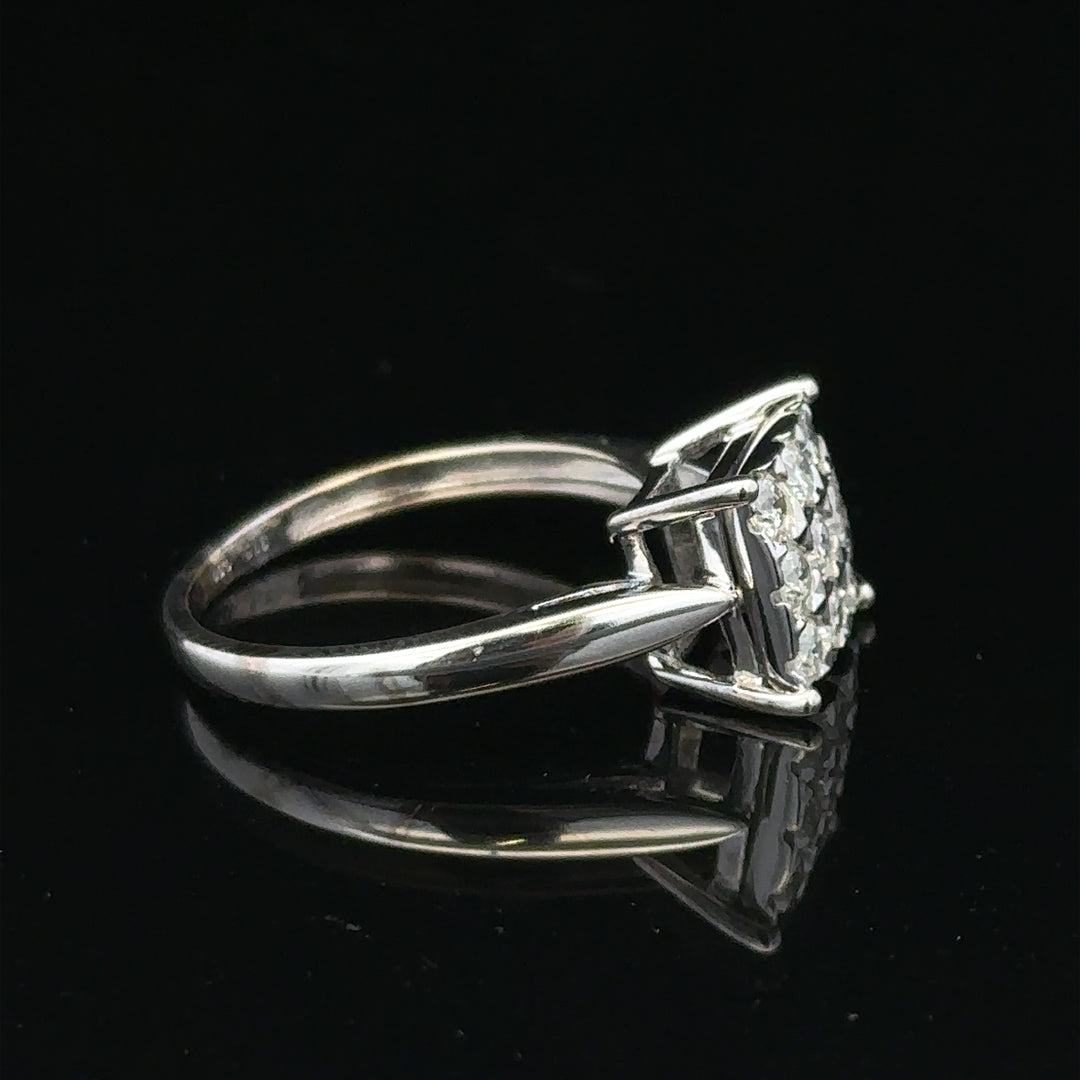 White gold diamond ring with half-carat center stone, featuring a sleek design and sparkling diamonds, unbranded jewelry piece.