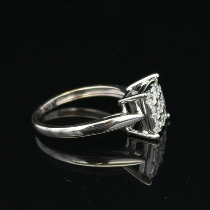 White gold diamond ring with half-carat center stone, featuring a sleek design and sparkling diamonds, unbranded jewelry piece.