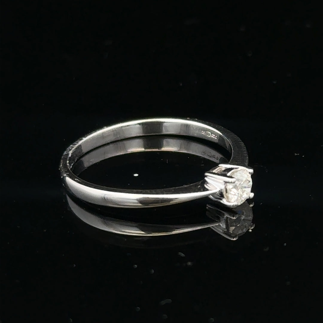 18ct white gold diamond ring with 1/4 carat solitaire, size P1/2, featuring a sparkling diamond setting.