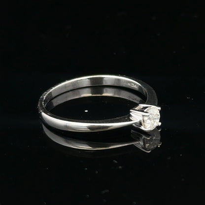 18ct white gold diamond ring with 1/4 carat solitaire, size P1/2, featuring a sparkling diamond setting.
