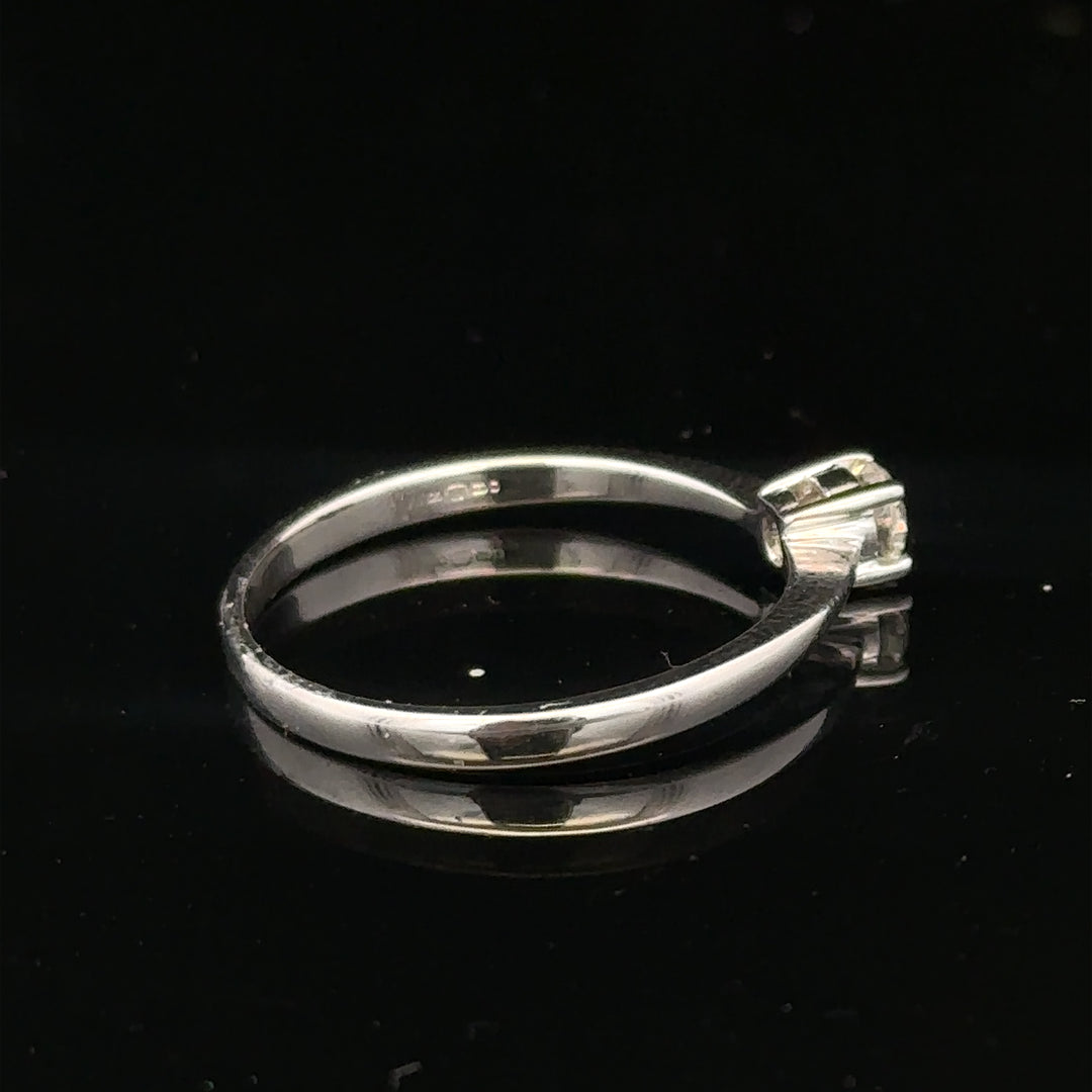 18ct white gold diamond ring with 1/4 carat total weight, size P1/2, featuring a sparkling diamond centerpiece.