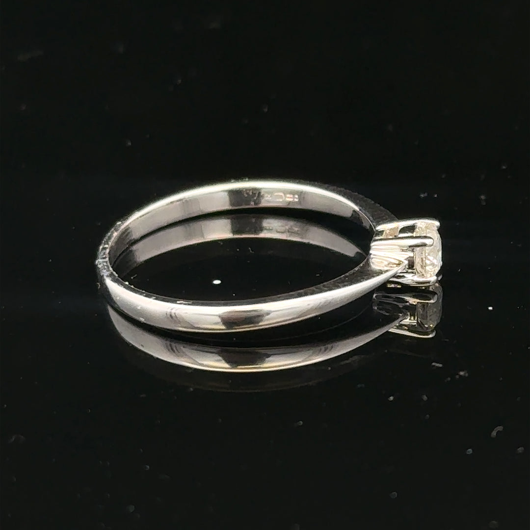 18ct white gold diamond ring with 1/4 carat solitaire, size P1/2, featuring a sparkling diamond gemstone.