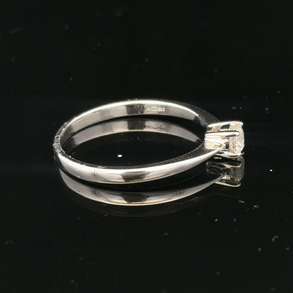 18ct white gold diamond ring with 1/4 carat solitaire, size P1/2, featuring a sparkling diamond gemstone.