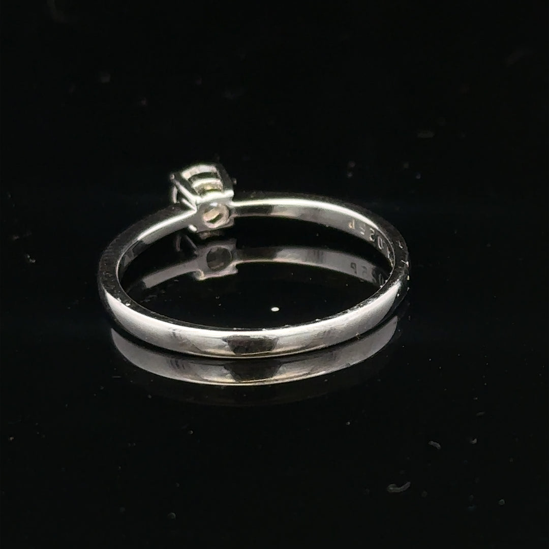 18ct white gold diamond ring with 1/4 carat solitaire, size P1/2, featuring a sparkling central diamond.