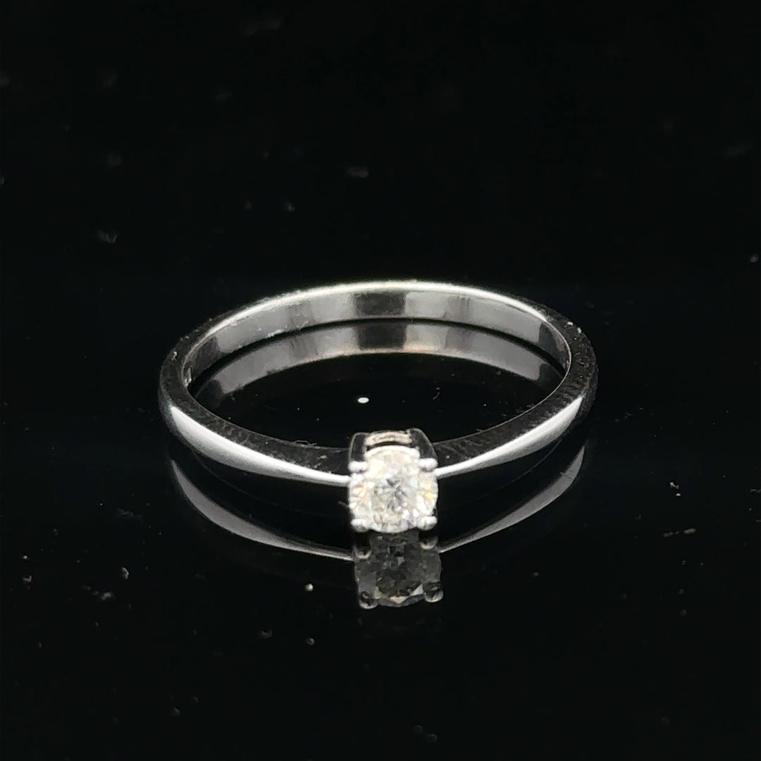 18ct white gold diamond ring with 1/4 carat solitaire, size P1/2, featuring a sparkling diamond setting.