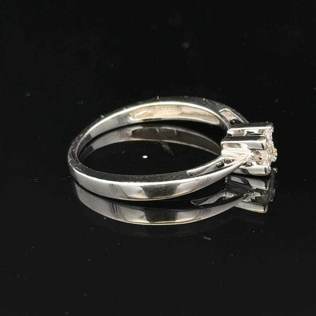 Elegant 9ct white gold diamond ring with sparkling gemstones, showcasing a sleek and polished design.