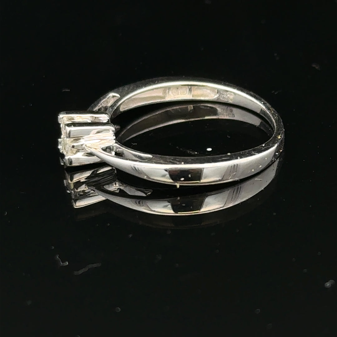 Elegant 9ct white gold diamond ring with sparkling diamonds, showcasing its intricate design and shiny finish.