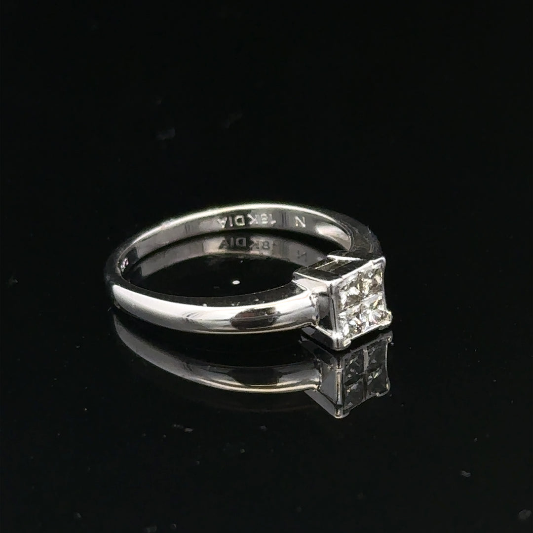 18ct white gold diamond ring with a central diamond, size J1/2, featuring elegant design and sparkling gemstones.