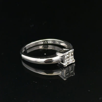 18ct white gold diamond ring with a central diamond, size J1/2, featuring elegant design and sparkling gemstones.