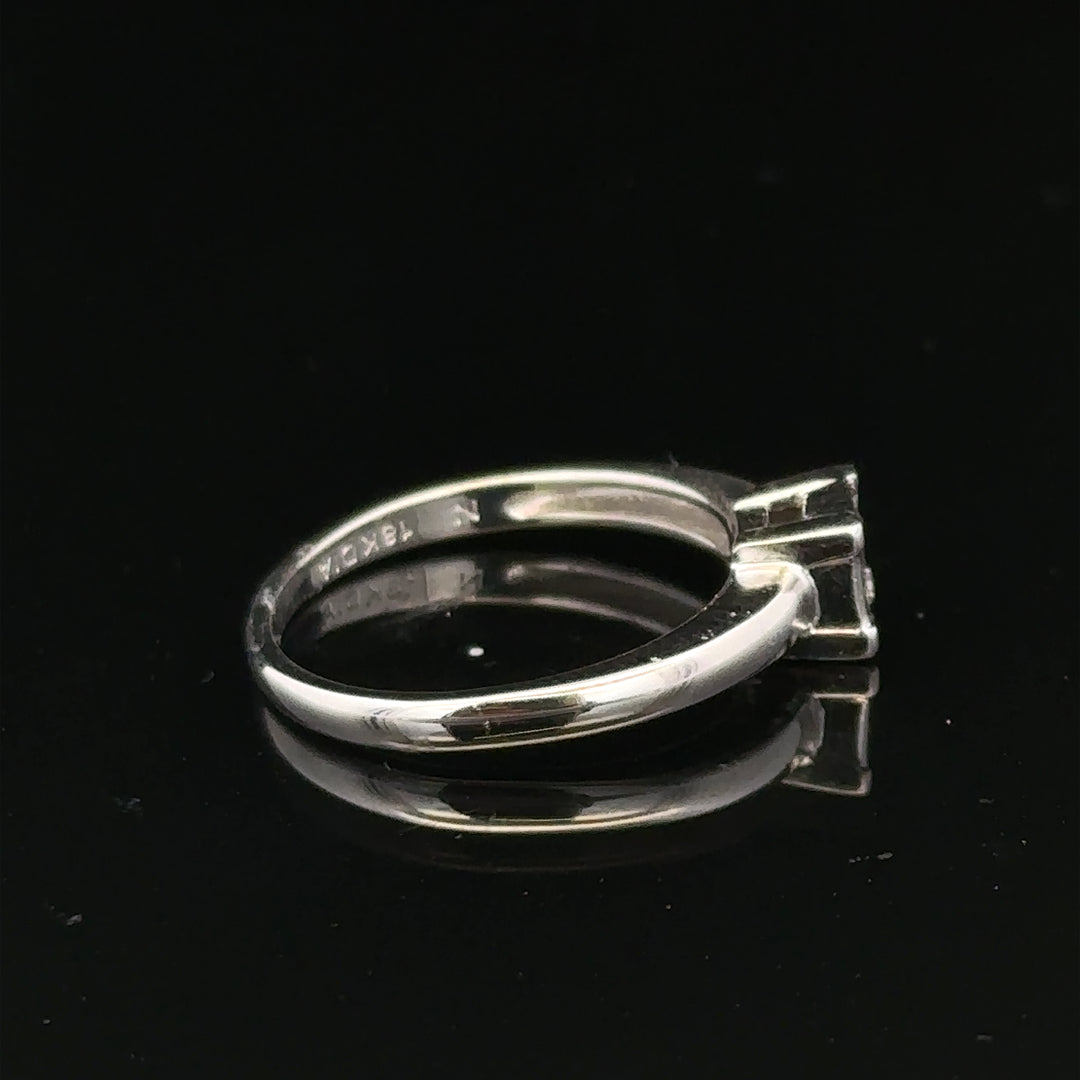 18ct white gold diamond ring with small diamonds, size J1/2, featuring a sleek and elegant design.