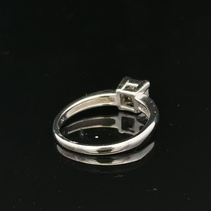 18ct white gold diamond ring with a central diamond, size J1/2, elegant jewelry piece with sparkling stones.