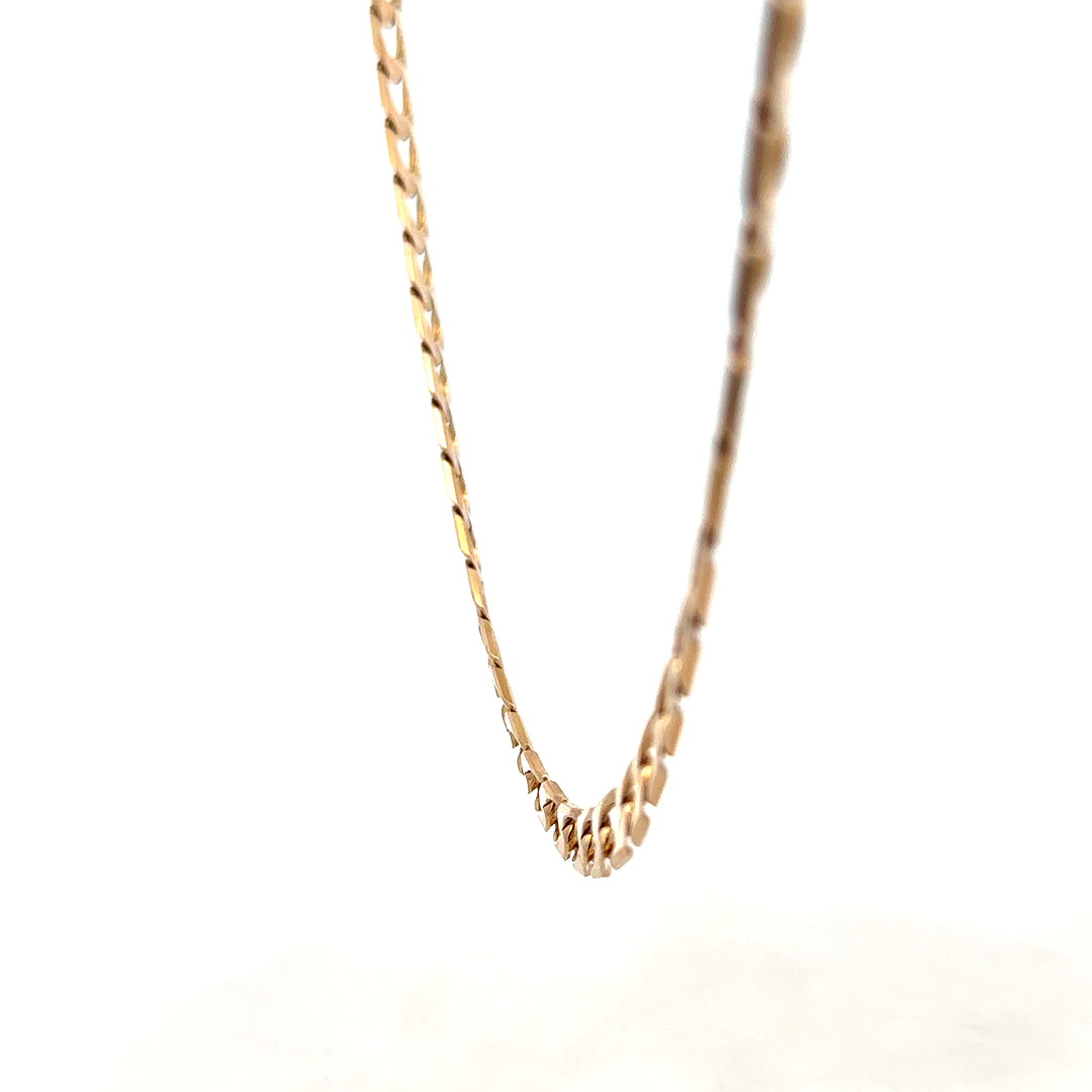 Reeves and Sons 9ct yellow gold curb chain, 27.6g, showing the detailed links and polished finish of the jewelry.