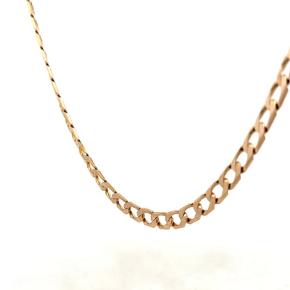 9ct yellow gold curb chain weighing 27.6g from Reeves and Sons, close-up showing smooth links and shiny finish.