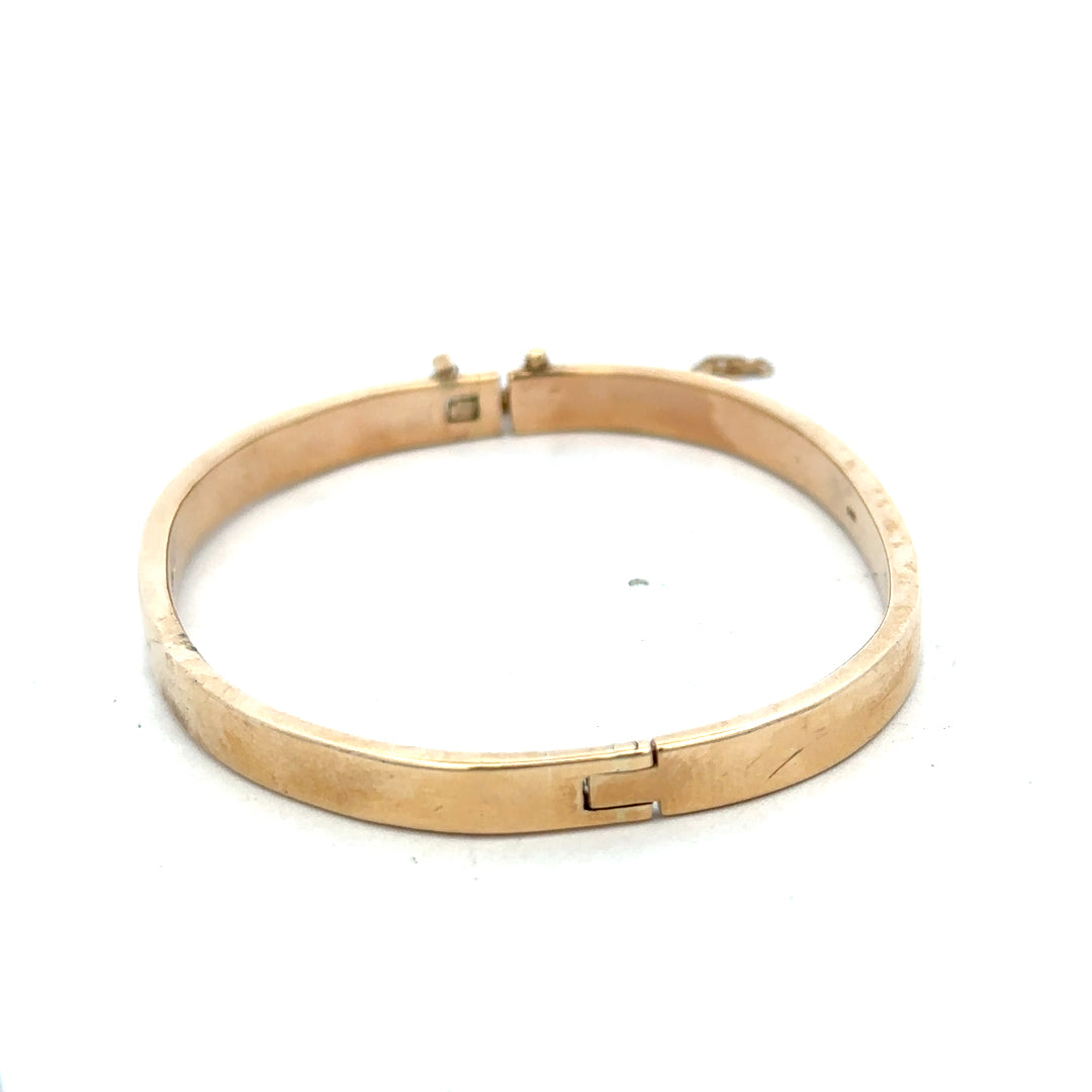 Reeves and Sons 9ct yellow gold bracelet bangle, 24.1g, polished smooth finish, circular design with subtle shine.