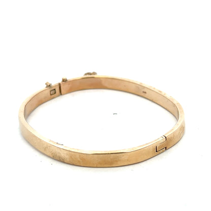 9ct yellow gold bracelet bangle with a smooth polished finish, weighing 24.1g, by Reeves and Sons.