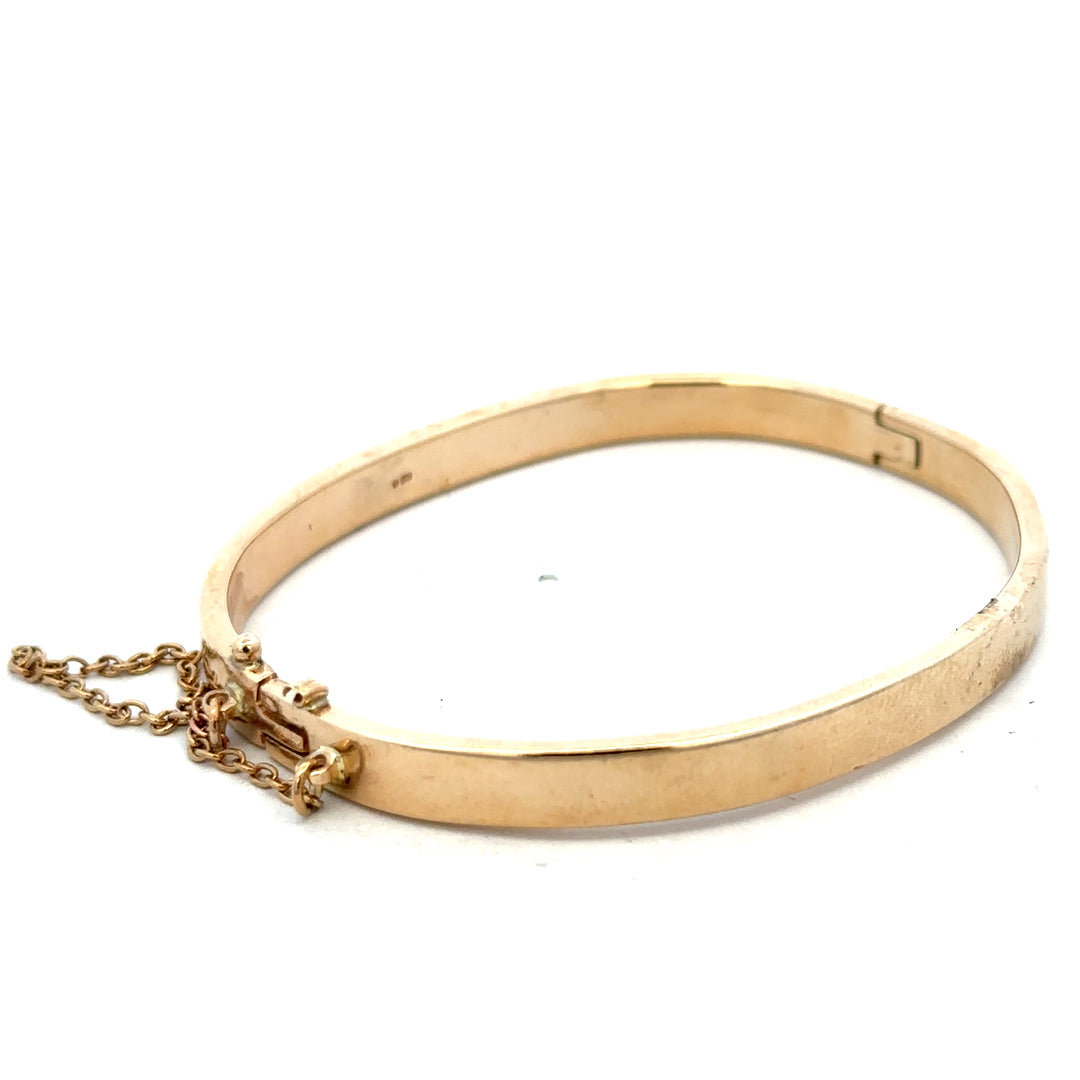Reeves and Sons 9ct yellow gold bracelet bangle weighing 24.1g, featuring a smooth polished finish and classic design.