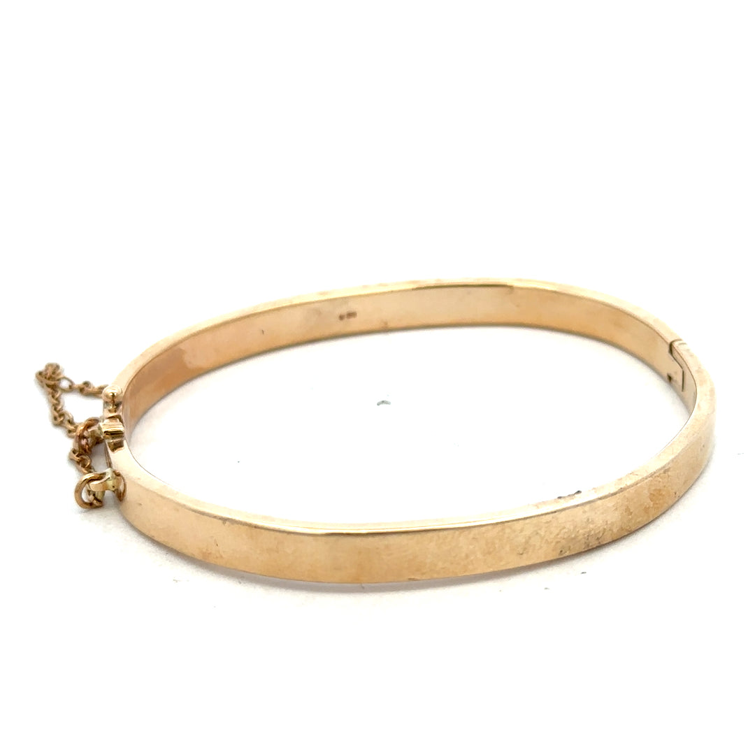 Reeves and Sons 9ct yellow gold bracelet bangle with a smooth, polished finish, weighing 24.1g, shown on a plain background.