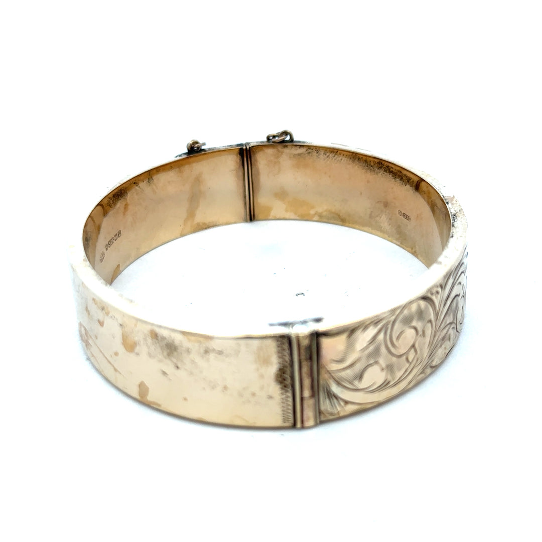Reeves and Sons 9ct yellow gold bangle bracelet, 22.7g, smooth polished finish, showcasing elegant jewelry design.