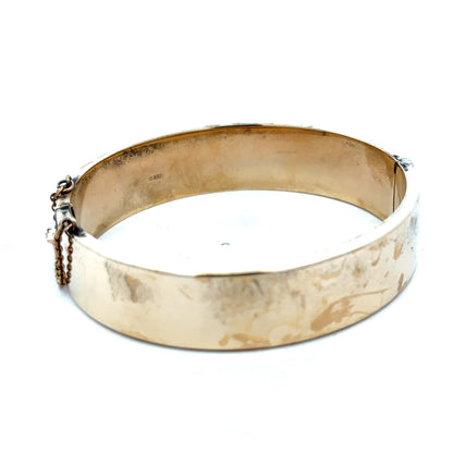 Reeves and Sons 9ct yellow gold bracelet bangle, weighing 22.7g, with smooth polished finish and classic design.
