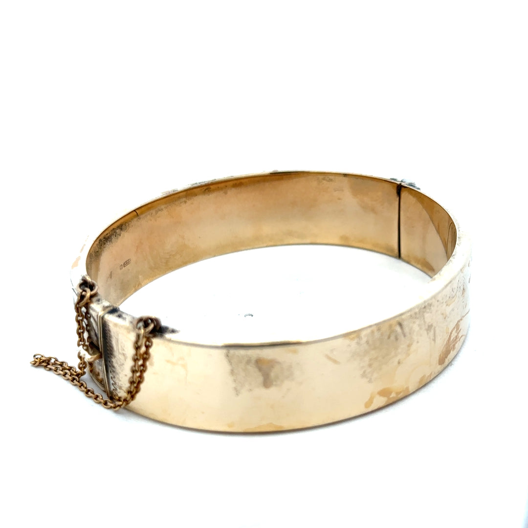 9ct yellow gold bangle bracelet weighing 22.7g from Reeves and Sons, featuring a smooth, polished finish.