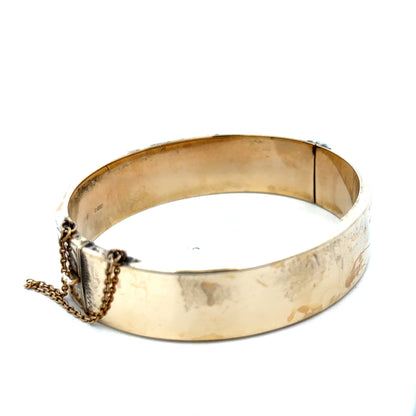 9ct yellow gold bangle bracelet weighing 22.7g from Reeves and Sons, featuring a smooth, polished finish.