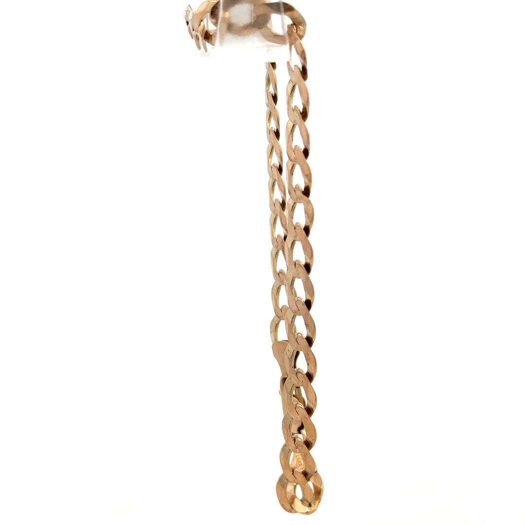 9ct yellow gold curb bracelet by Reeves and Sons, showcasing a sleek chain design with a polished finish.