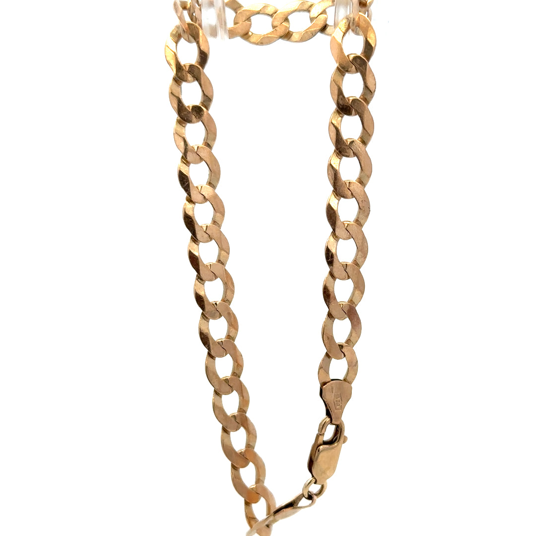 9ct yellow gold curb bracelet by Reeves and Sons with a polished finish, showcasing its linked chain design and secure clasp.