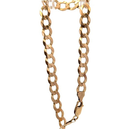 9ct yellow gold curb bracelet by Reeves and Sons with a polished finish, showcasing its linked chain design and secure clasp.