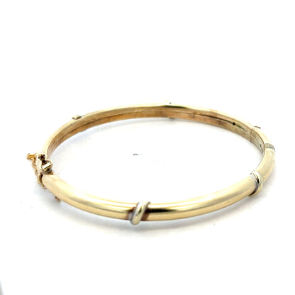 Reeves and Sons 9ct yellow gold bracelet bangle with a smooth, polished finish, weighing 11.1 grams.