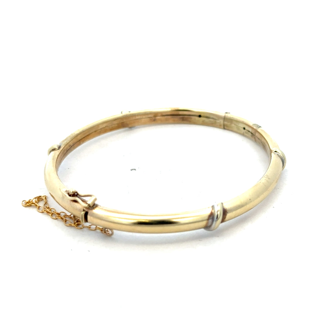 9ct yellow gold bangle bracelet weighing 11.1g from Reeves and Sons, showcasing a smooth, polished finish and elegant design.