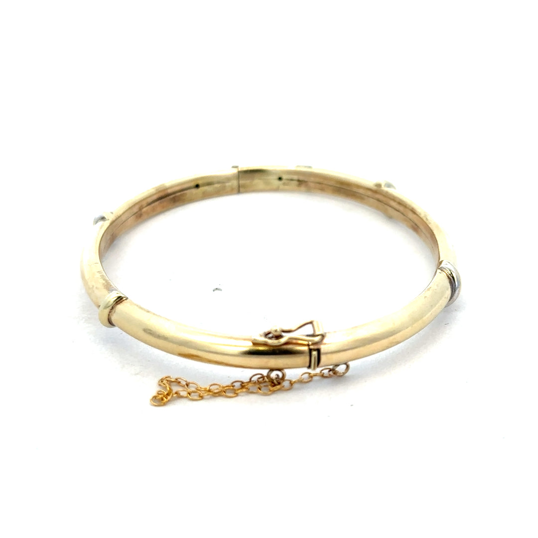 9ct yellow gold bracelet bangle with a smooth polished finish, weighing 11.1g, from Reeves and Sons.