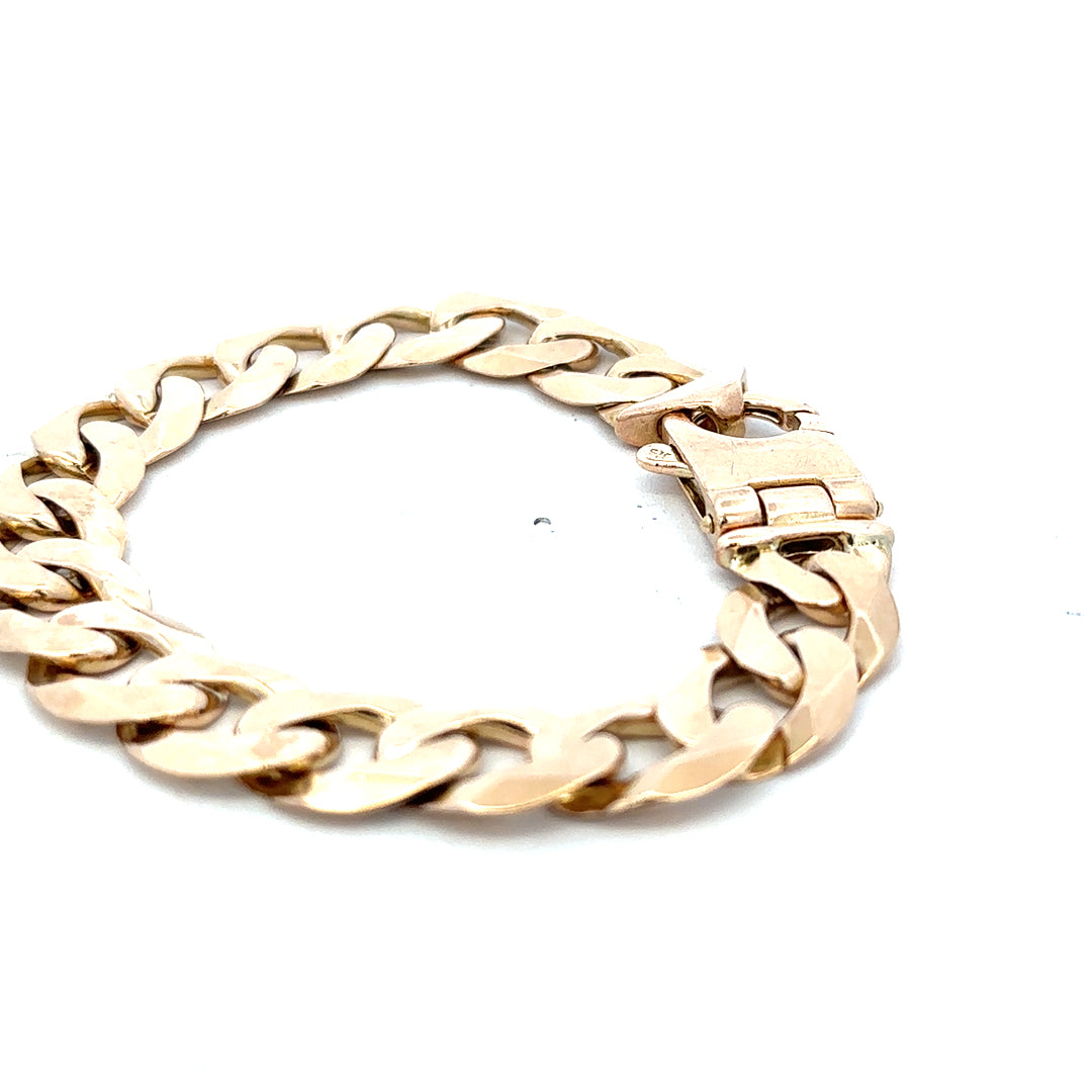 Reeves and Sons 9ct yellow gold curb bracelet with a weight of 48.1g, showcasing a polished gold chain design.