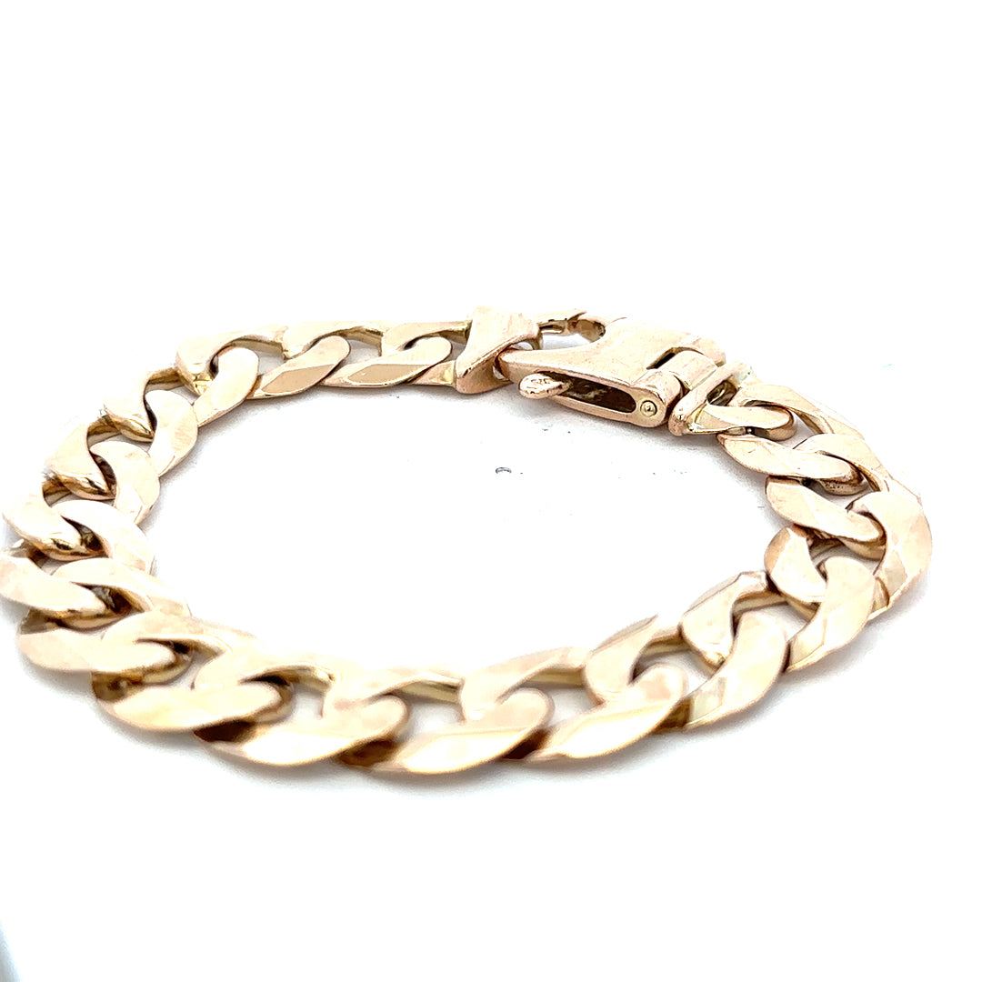 9ct yellow gold curb bracelet with a polished finish, weighs 48.1g, featuring linked oval design, by Reeves and Sons.