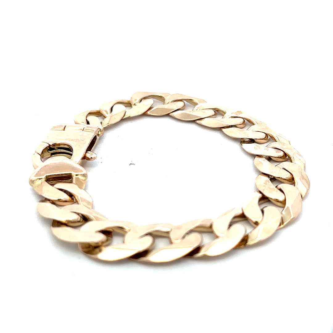 9ct yellow gold curb bracelet from Reeves and Sons, showcasing bold links and a polished finish.
