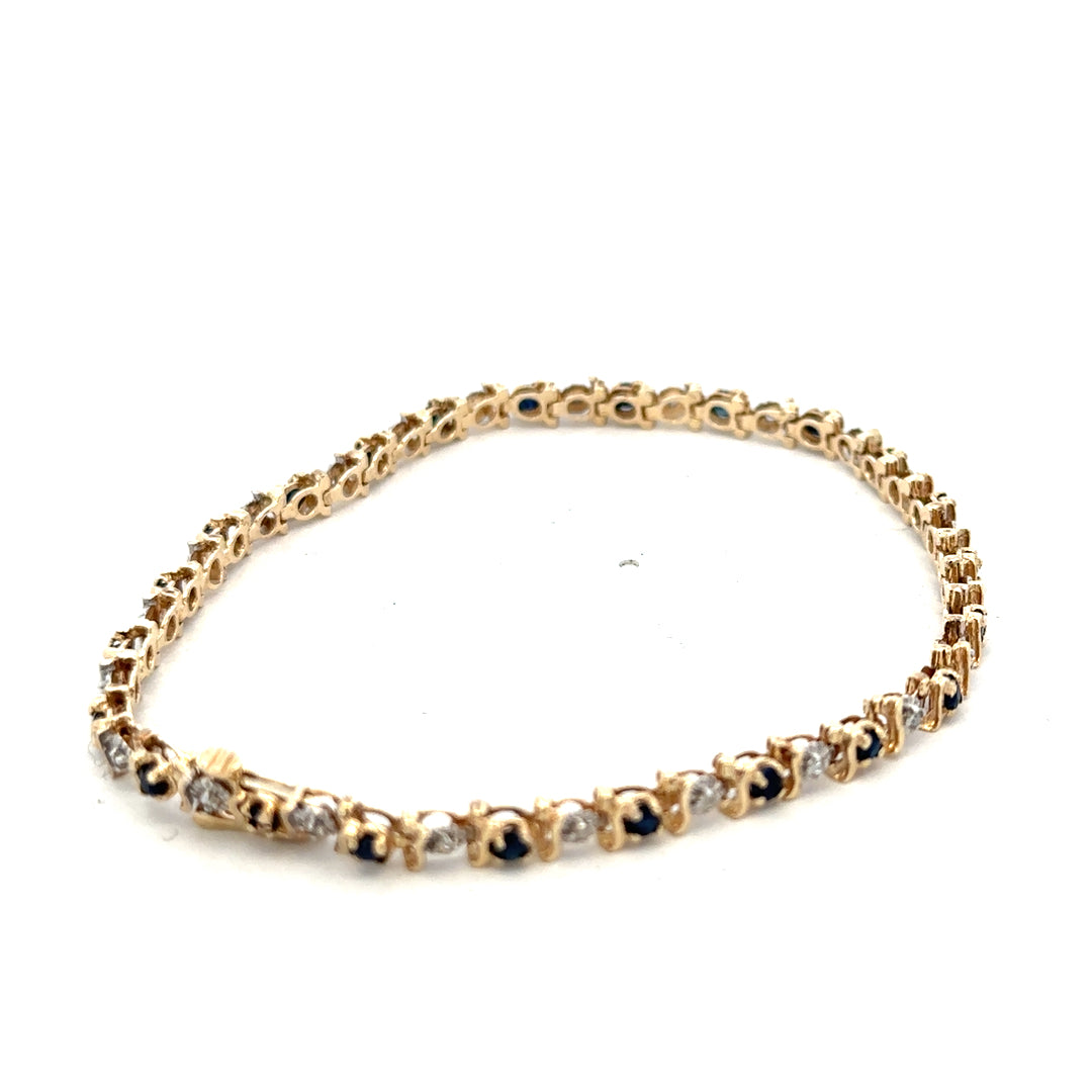 9ct yellow gold sapphire and diamond bracelet with intricate design, weighing 6.5g, by Reeves and Sons.