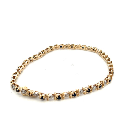 9ct yellow gold sapphire and diamond bracelet with intricate design, weighing 6.5g, by Reeves and Sons.
