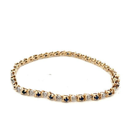 9ct yellow gold sapphire and diamond bracelet from Reeves and Sons, featuring a delicate chain with sparkling gemstones.