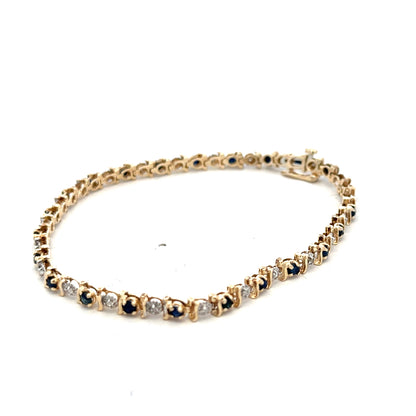 9ct yellow gold sapphire and diamond bracelet with intricate design, weighing 6.5g, from Reeves and Sons.