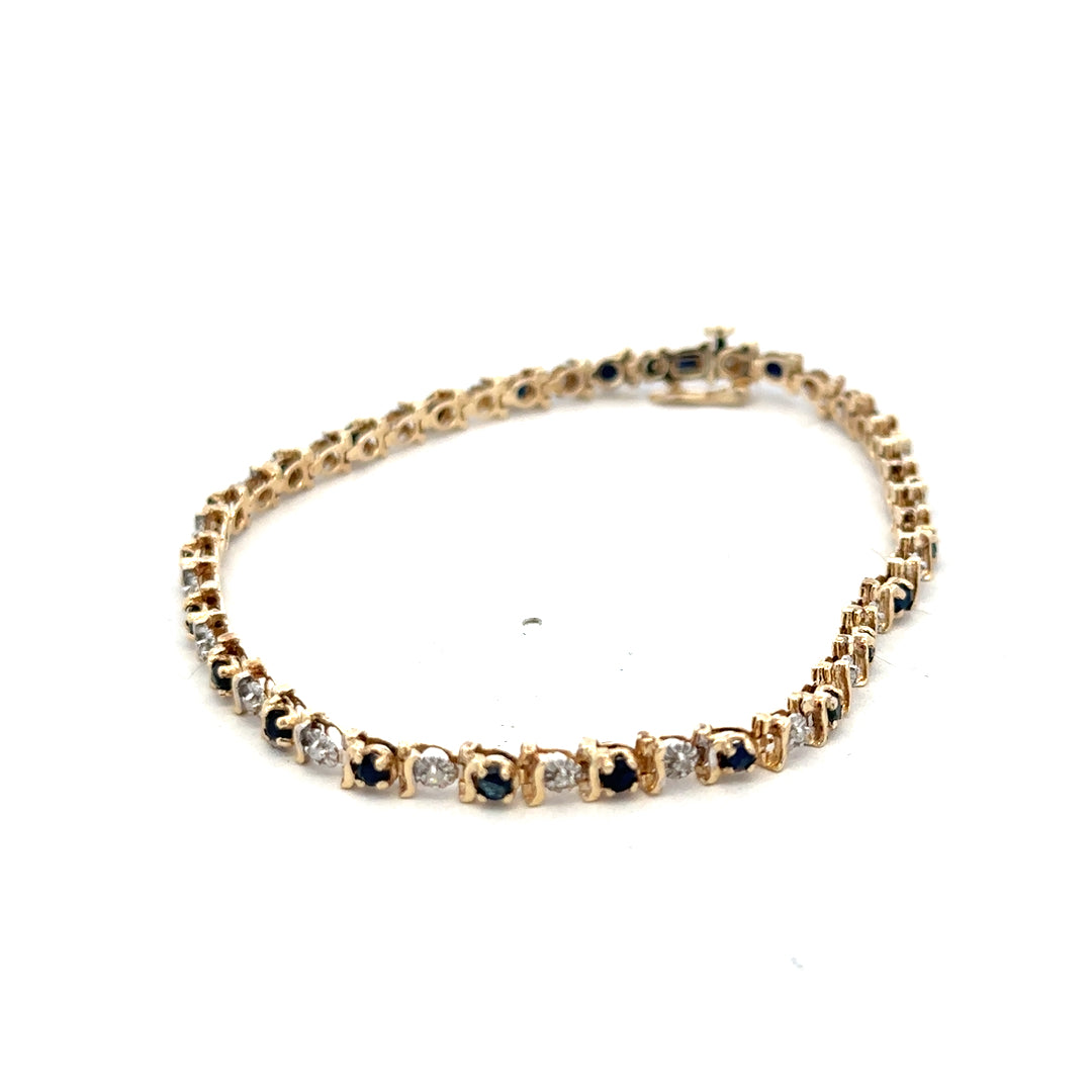 9ct yellow gold sapphire and diamond bracelet by Reeves and Sons, featuring sparkling gemstones on a delicate chain.