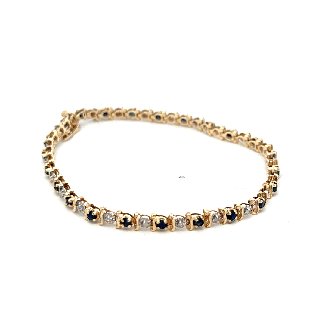9ct yellow gold sapphire and diamond bracelet with intricate design, weighing 6.5g, from Reeves and Sons.