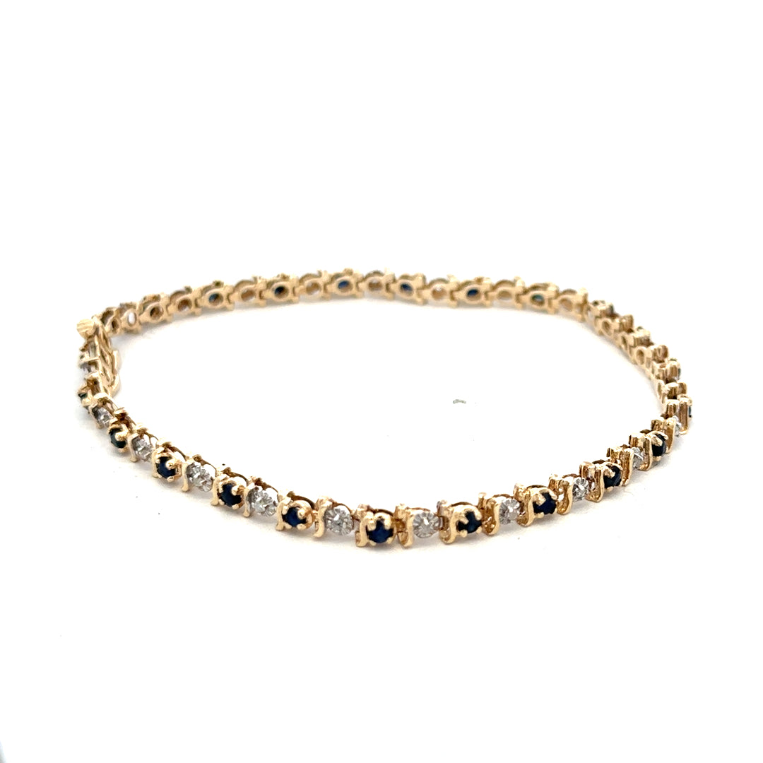 Reeves and Sons 9ct yellow gold sapphire and diamond bracelet with intricate design, weighing 6.5g.