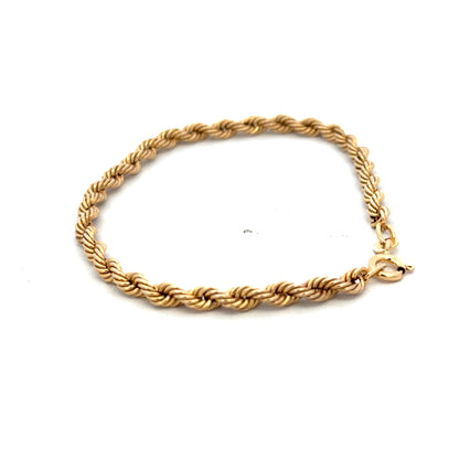 9ct yellow gold rope bracelet weighing 2.4g, featuring a twisted design, by Reeves and Sons, displayed on a neutral background.