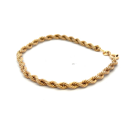 9ct yellow gold rope bracelet by Reeves and Sons, lightweight jewelry piece with intricate twisted design and secure clasp.