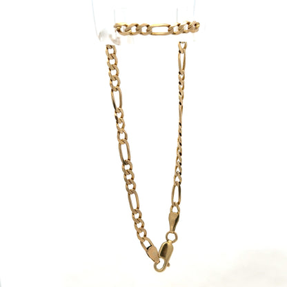 9ct yellow gold figaro bracelet by Reeves and Sons, showcasing polished chain links and elegant craftsmanship.