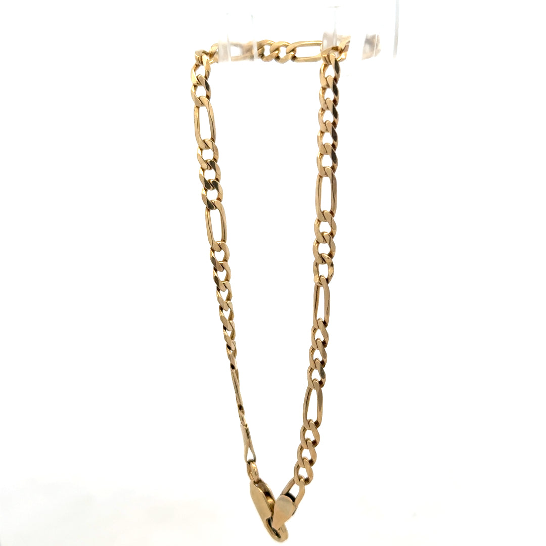 9ct yellow gold figaro bracelet by Reeves and Sons, 4.2g, featuring linked chain design, close-up view of shiny gold jewelry