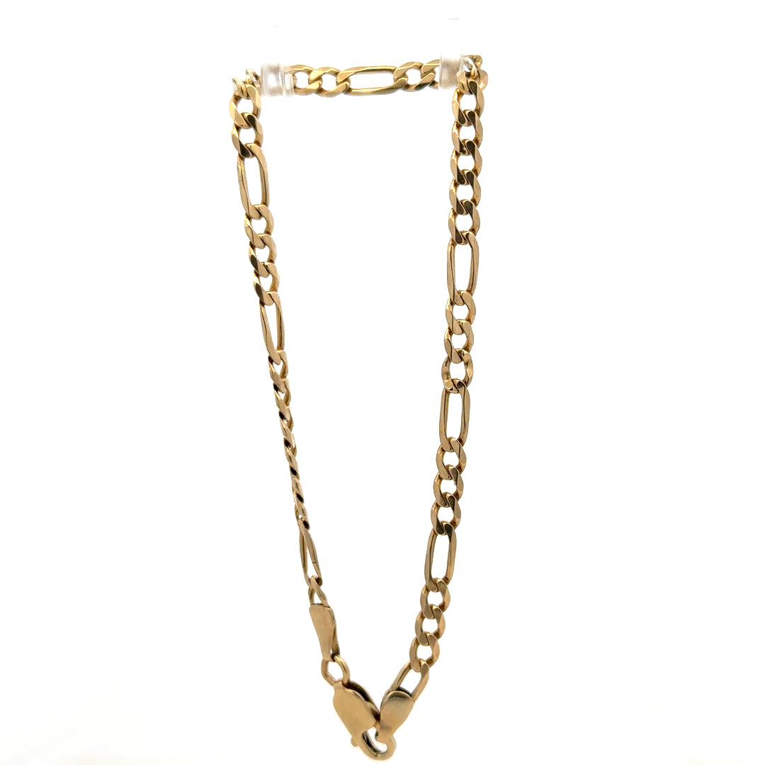 9ct yellow gold Figaro bracelet by Reeves and Sons, showing polished links and elegant design on a neutral background.