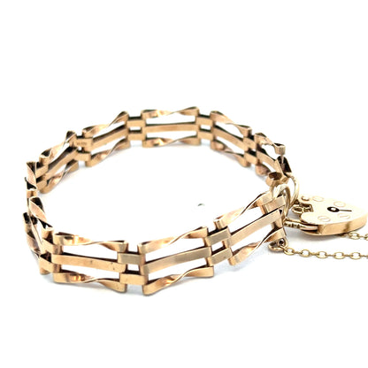 9ct yellow gold gate bracelet by Reeves and Sons, featuring linked chain design, weighs 8.4g, close-up view of intricate links.
