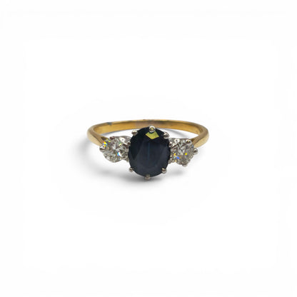 9ct yellow gold sapphire and diamond ring by Reeves and Sons, featuring a central sapphire gemstone with diamond accents.